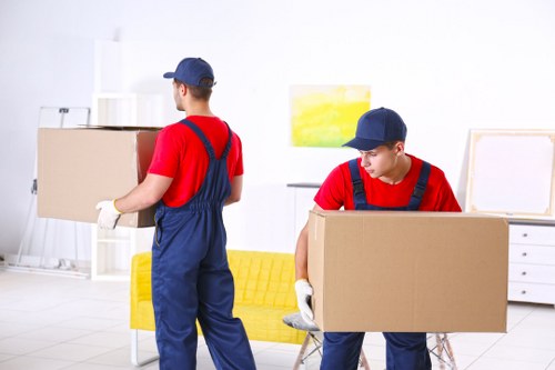 Removal team handling boxes and furniture during a Dulwich home move