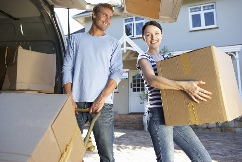 Movers carrying belongings from a top-floor flat in Dulwich
