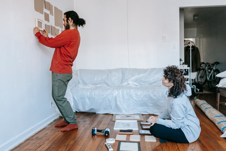 A spacious, elegantly decorated hall with high, arched ceilings and large, multi-pane windows allowing natural light to fill the room. The interior features white walls with decorative moldings and fr